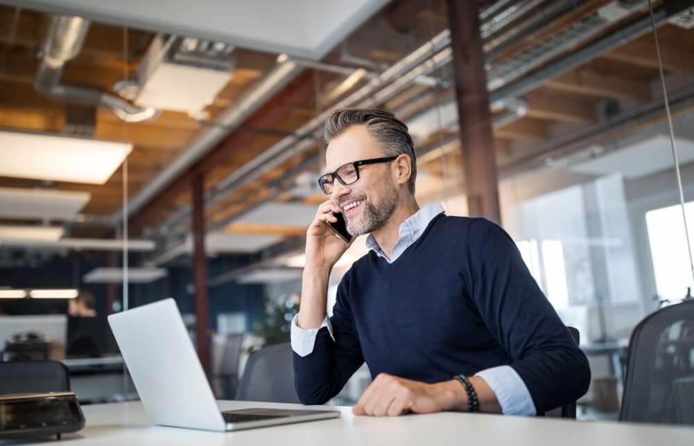 man wearing glasses at his laptop