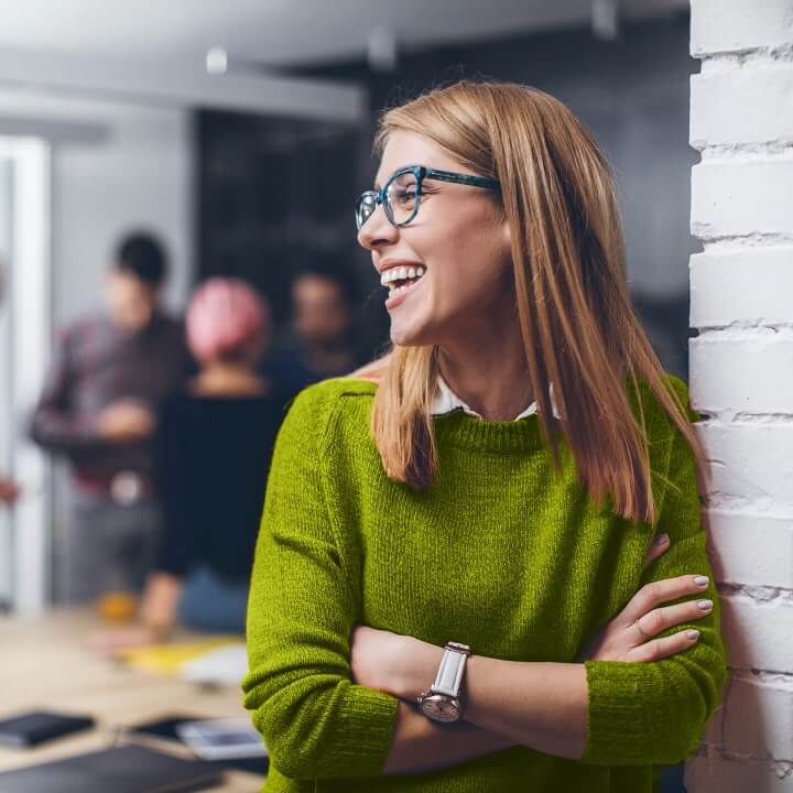 women smiling and wearing glasses